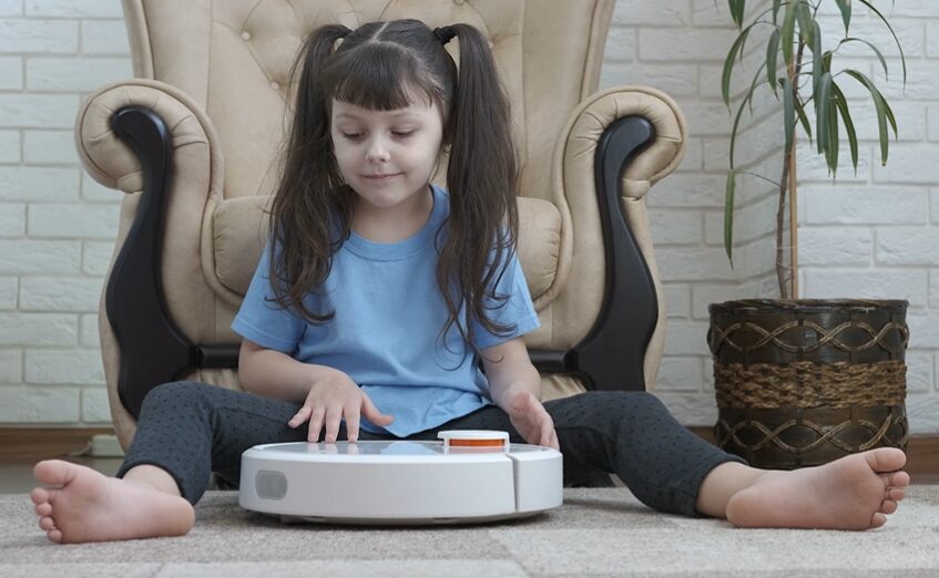 girl with robot vacuum